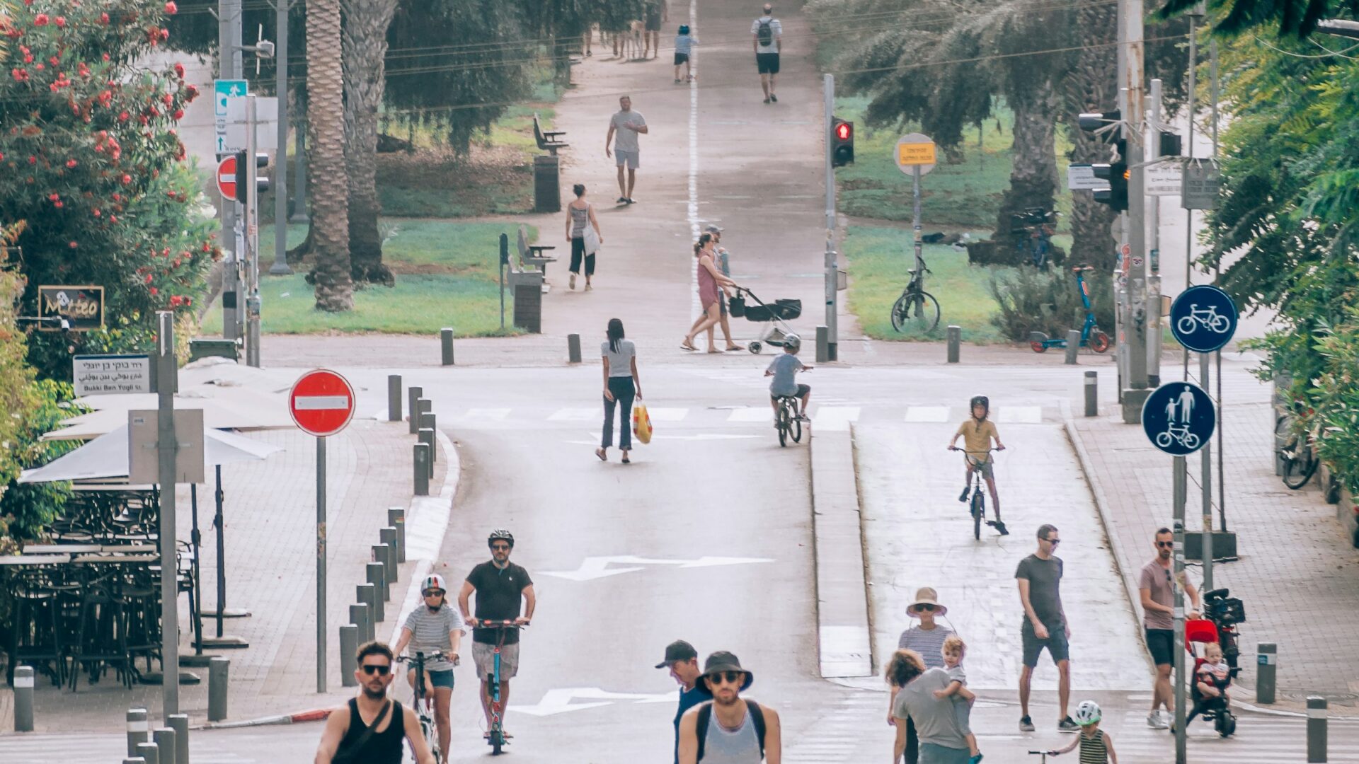 תושבים הולכים ורוכבים ברחוב עירוני בתל אביב